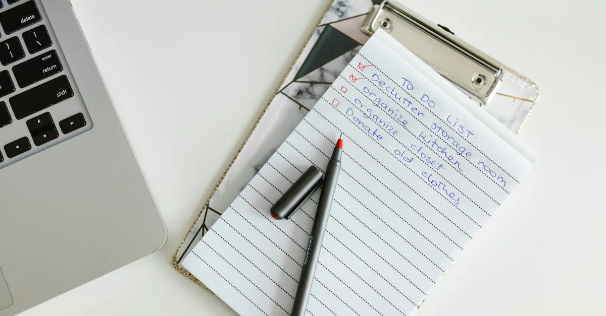 Printed list on a clipboard beside a laptop — sorting lines of text alphabetically
